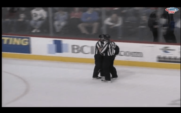 That's linesman Jud Ritter skating over to the scorers table with Miller....